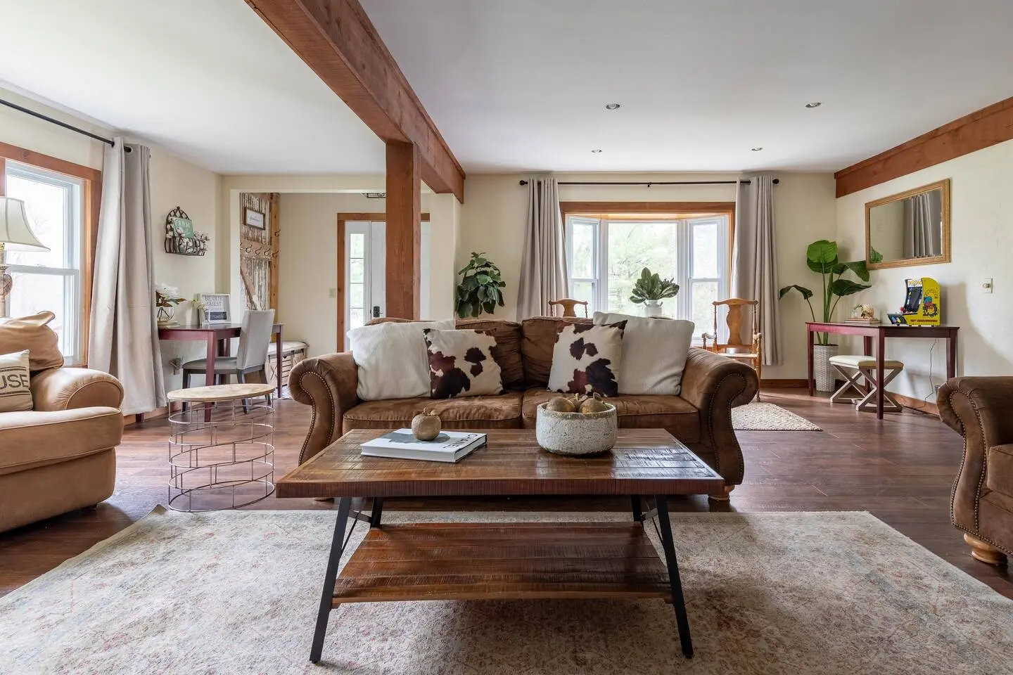 Living room with exposed wood beams and sofas