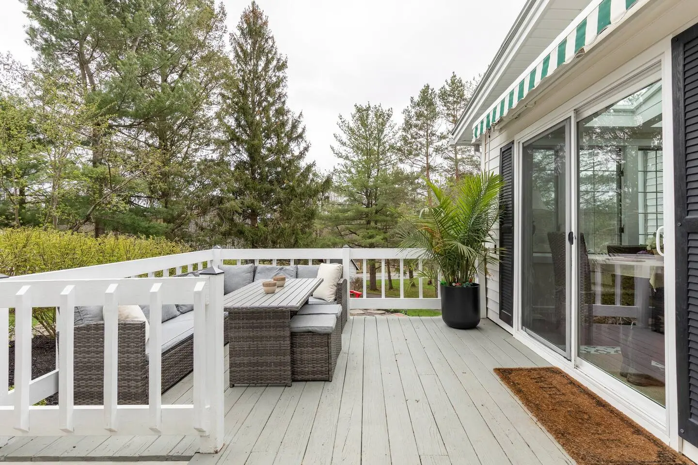 Deck with an outdoor sofa beside the screened porch