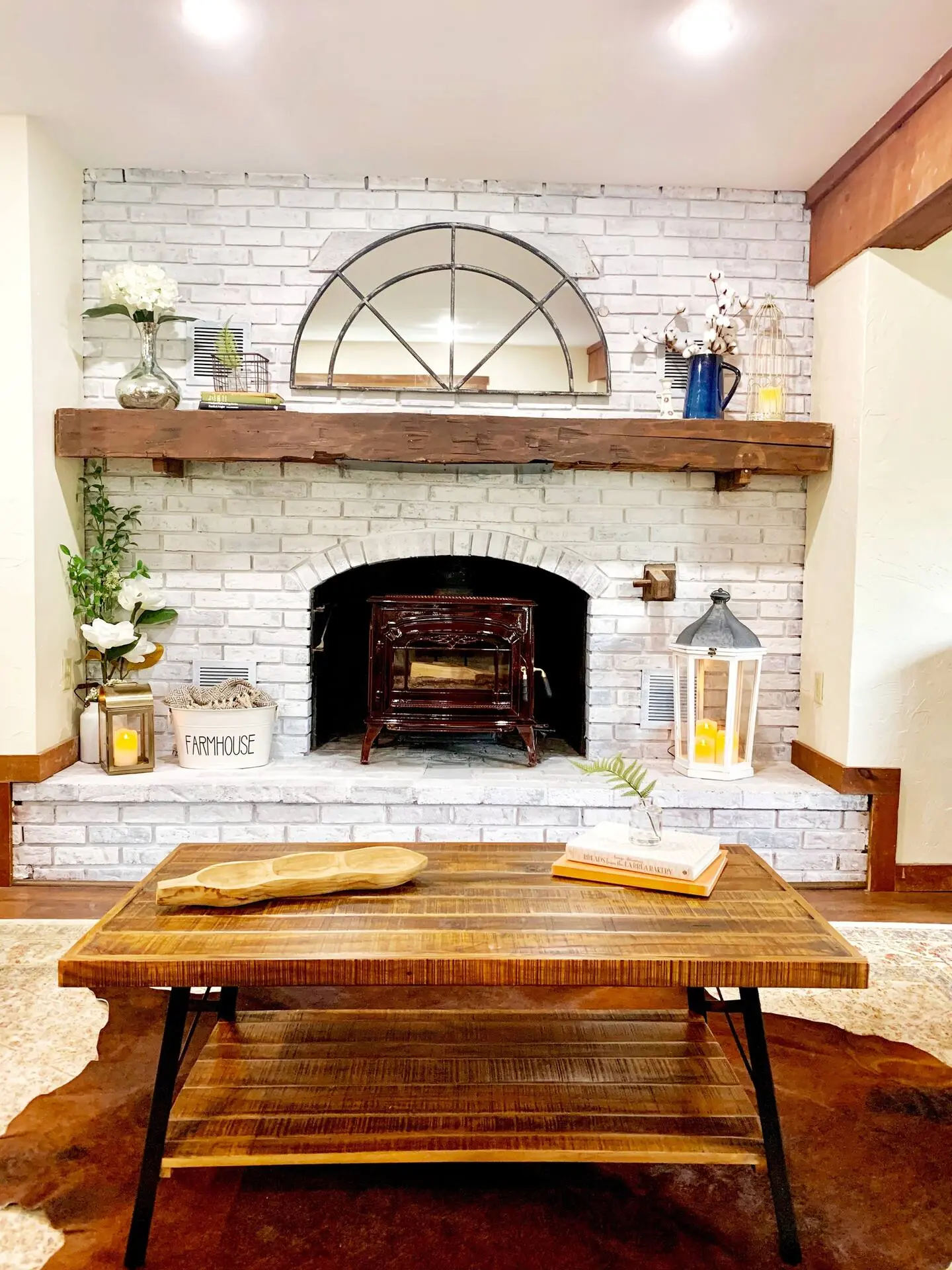 Stone fireplace with a wood mantel and coffee table